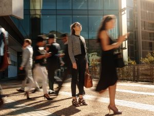 People in professional attire on a city sidewalk