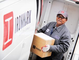 An Ironmark employee loading a van