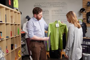 An Ironmark sales rep showing a shirt to a customer