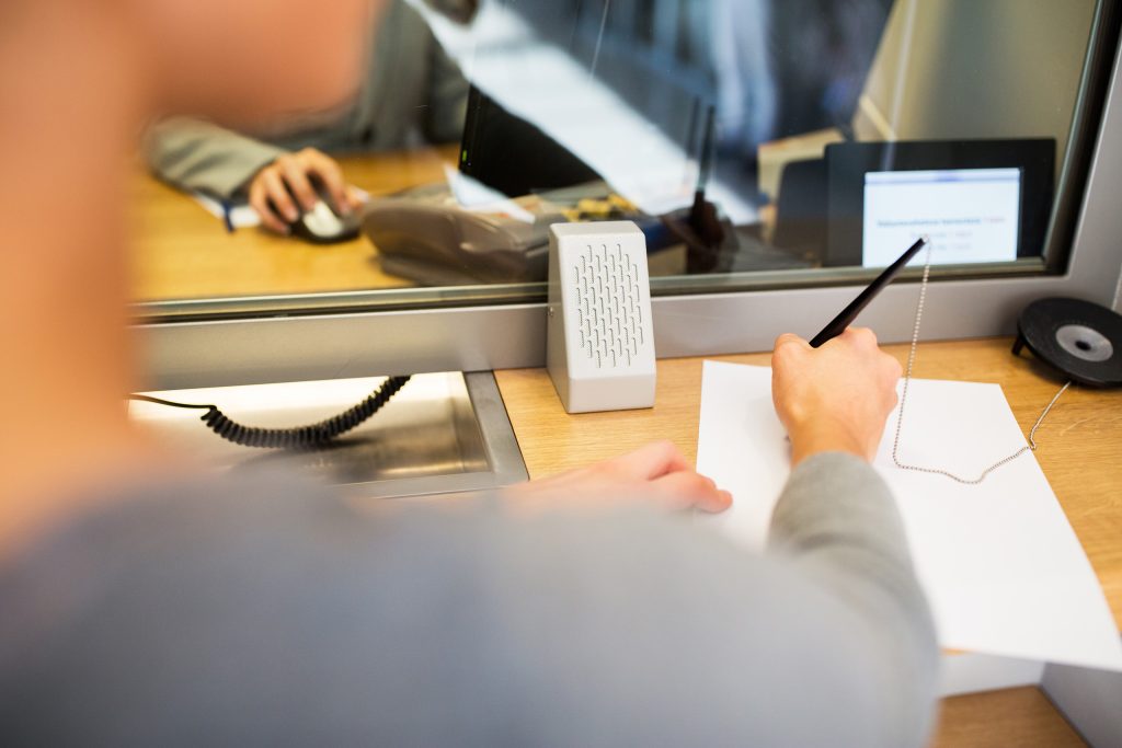 A bank teller writing on a piece of paper