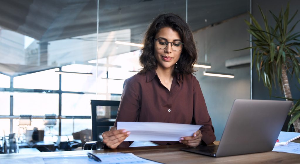 A woman looking at papers on a desk