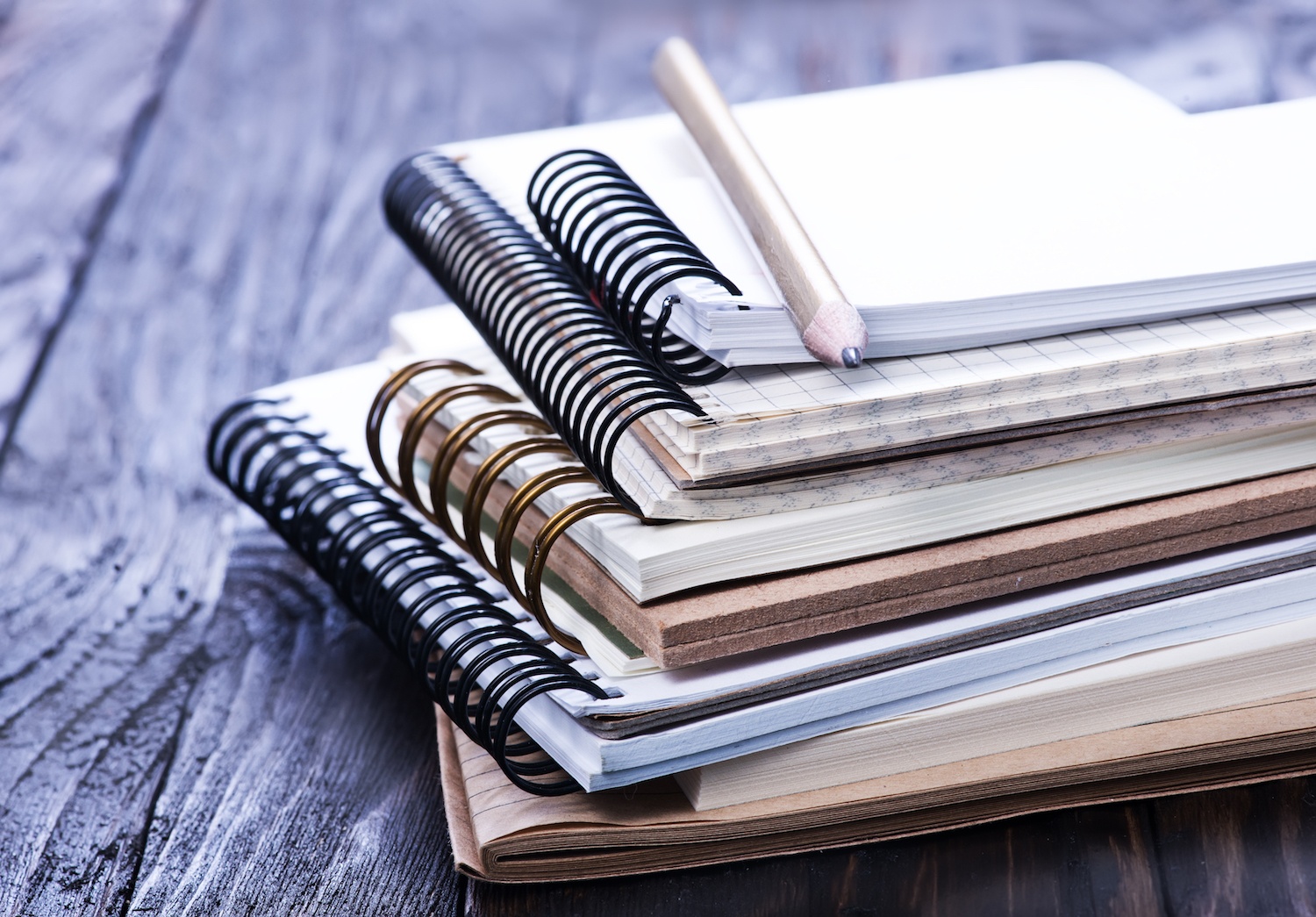 stack of spiral bound books