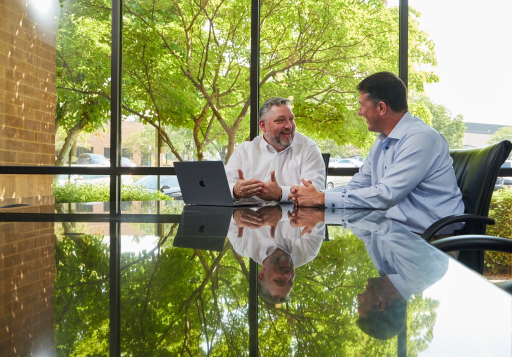 Matt Marzullo (left) and Jeff Ostenso (right) collaborating in a conference room.